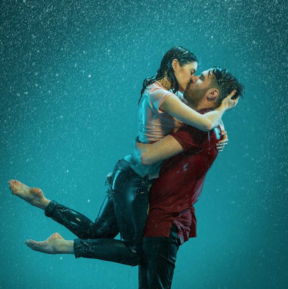 Dance couple kissing in the rain